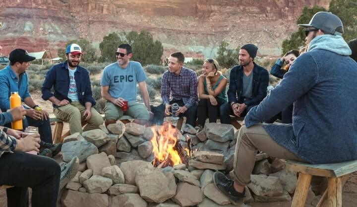 Image of a group of people gathering around a bonfire