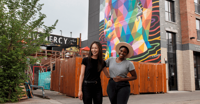 Friends in front of a colorful building in Edmonton