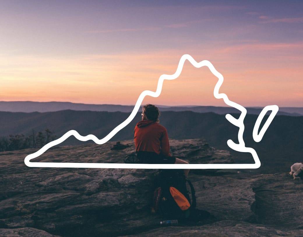 A hiker admiring the picture-perfect view atop of McAfee Knob