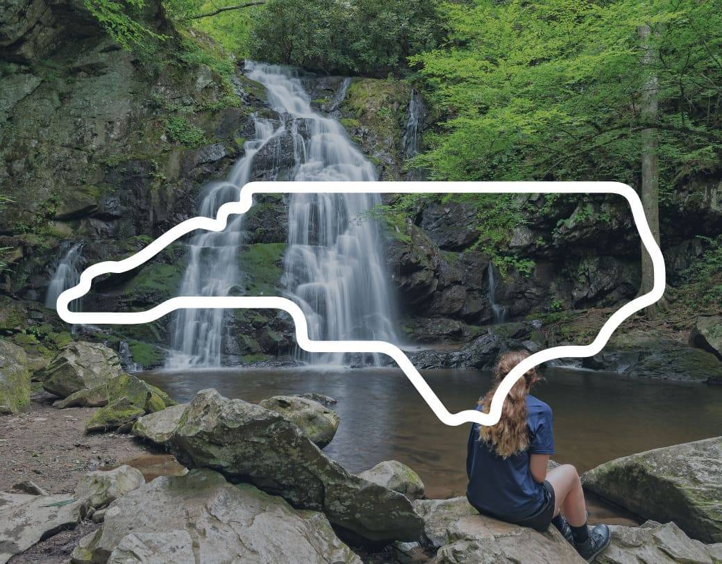 A woman hiker admiring the view of a waterfall along the Appalachian Trail in the Smokies