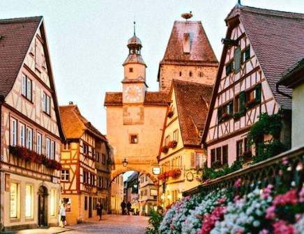An Indian woman smiling with a bowl balanced on her head