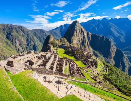 A woman wearing a bright yellow dress strolling through the picturesque blue streets of Chefchaouen