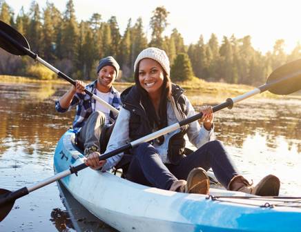 A couple kayaking together on a pristine lake in the United States