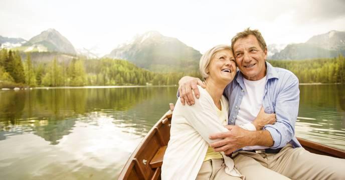 An elderly couple enjoying a peaceful float on a pristine European lake