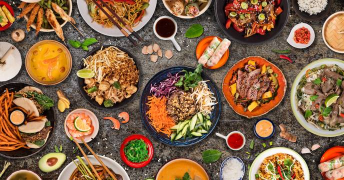 richly set table with all kinds of colorful asian delicacies