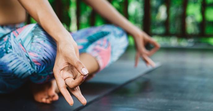 Close up of a woman in shavasna at a yoga retreat in Asia