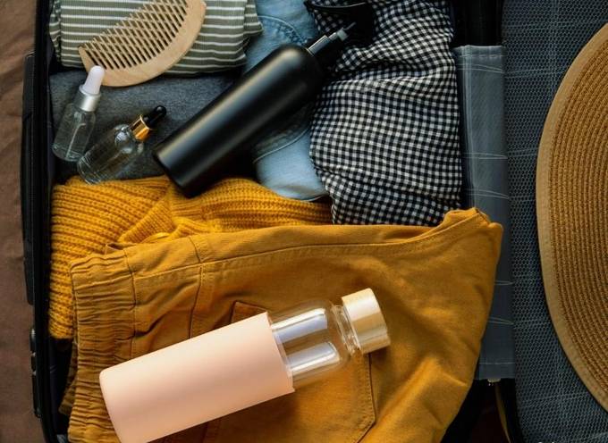 An open suitcase with biodegradable and reusable products