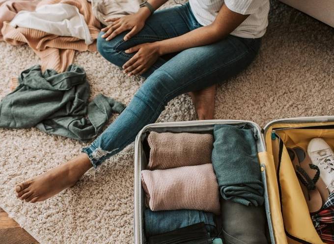 A woman packing her suitcase with only the essentials needed for her TourRadar organized adventure