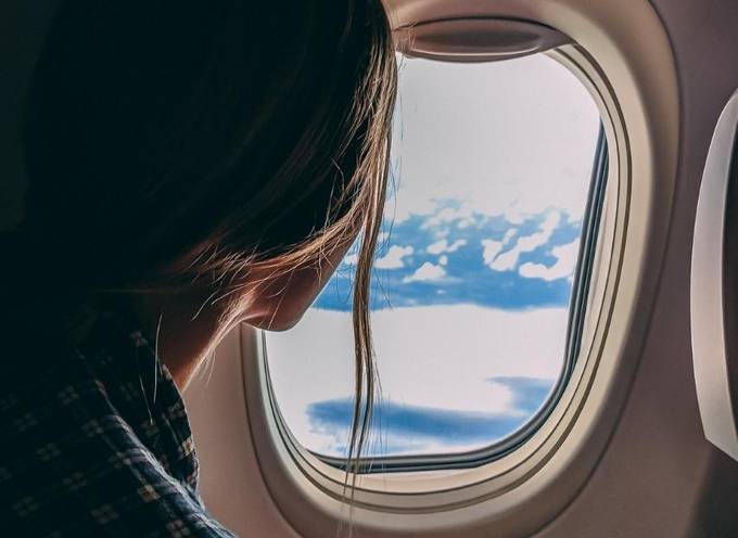 A person flying on an airplane that uses sustainable aviation fuel (SAF)