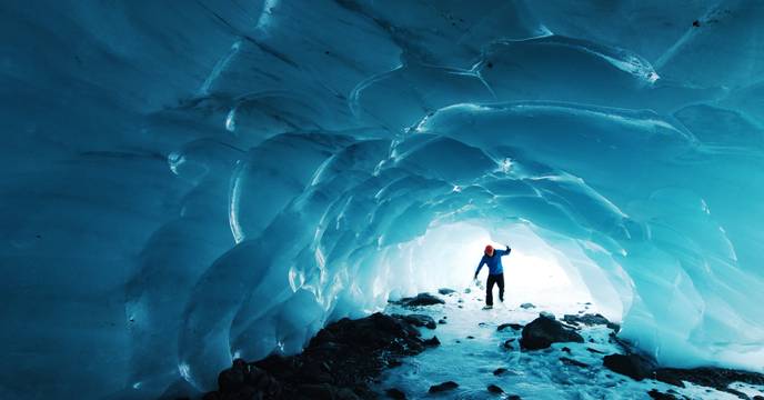 A person exploring an ice cave