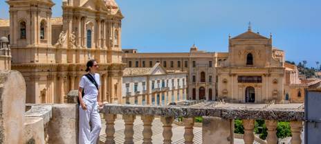 Woman enjoying a view of a picturesque city in Italy