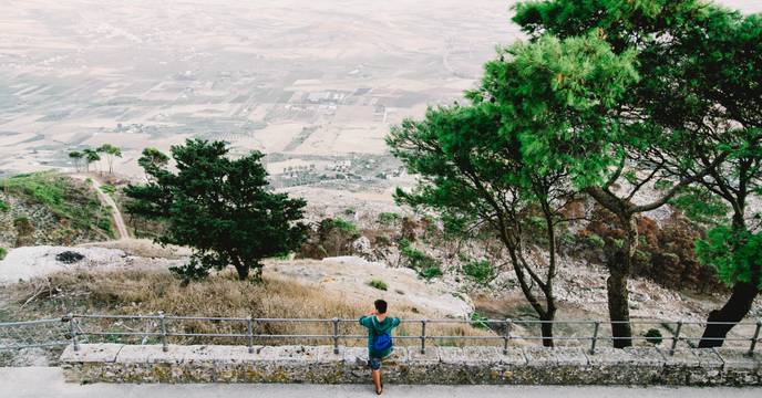 Person enjoying sweeping views of hills and fields