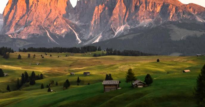 Alpenglow painting the Dolomites in orange and pink