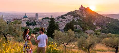 Couple enjoying a glass of wine and a spectacular sunset
