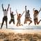 Friends jumping at the beach