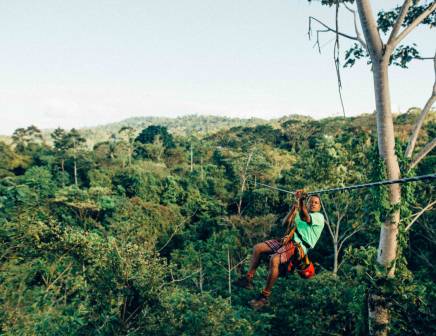 Man zip lining above the Costa Rican jungle.