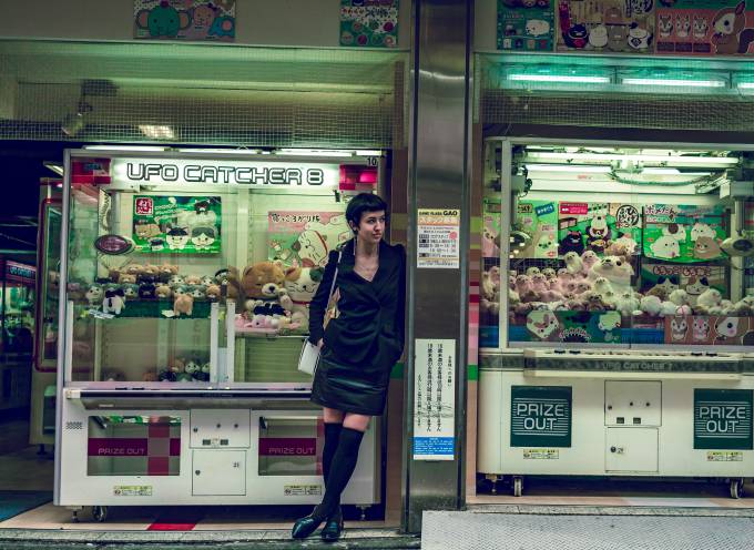 Young woman standing in front of claw machines
