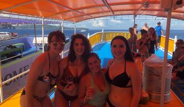 Group of women on a boat smiling and holding drinks.