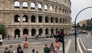 Colosseum with people walking around in Rome.