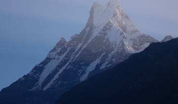 Snow-capped mountain peak under a clear sky.