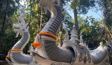 Decorative dragon sculptures amidst foliage.