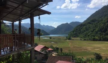 Scenic view from a balcony overlooking fields and mountains in Vietnam.