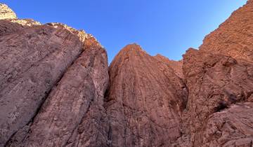 Tall rock formations against a clear blue sky.
