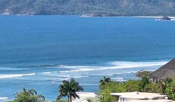 Coastal view with the ocean and distant hills.