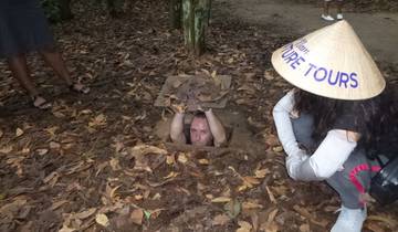 A person emerging from a tunnel with a local hat.