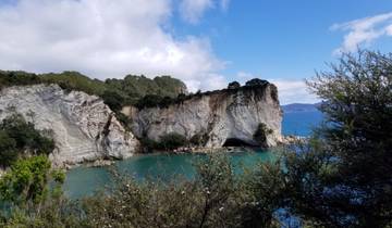 Scenic cove with turquoise water surrounded by cliffs.