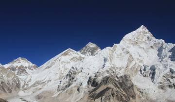 Close-up of mountains with prominent peaks against a clear blue sky.
