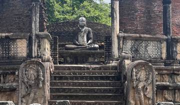 Ancient ruins with a Buddha statue in a meditation pose.