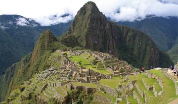 View of Machu Picchu ruins with mountains in the background.