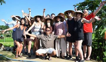 Large group of people outdoors, smiling and posing.