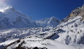 Snow-covered mountains under a clear blue sky.