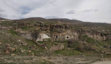 Rocky landscape with ancient structures.