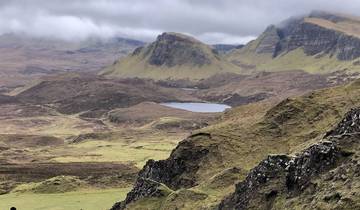 Hilly lands with a small lake surrounded by dramatic cliffs.