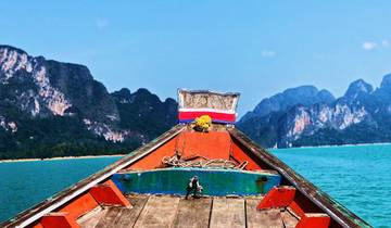 View from a traditional longboat towards mountains and blue water.