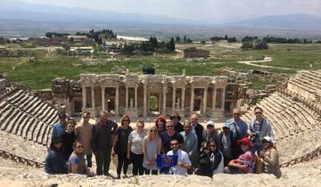 Tour group posing at ancient Roman ruins.