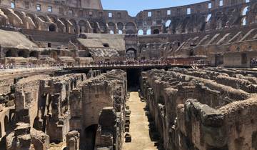 Interior view of the ancient Colosseum with tourists.