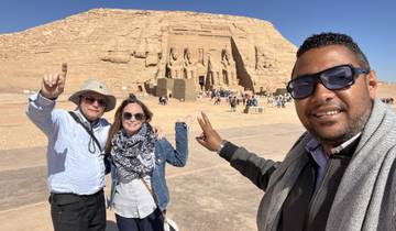 Three people posing in front of the Abu Simbel temple.
