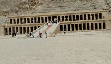 Temple with colonnades and tourists.