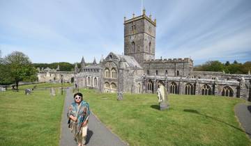 Person in front of an old cathedral in St Davids.