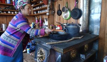 A woman cooking in a traditional kitchen setting.