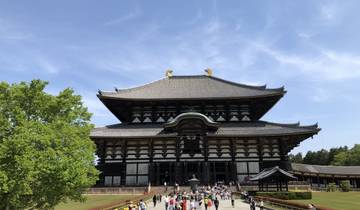 Large traditional Japanese temple with people around.