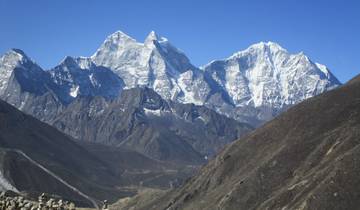 Majestic snow-covered peaks against a clear blue sky.