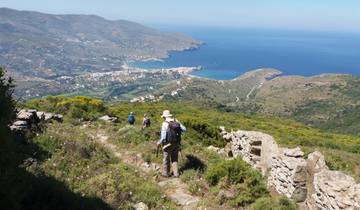 Hikers overlooking a coastal town and sea.