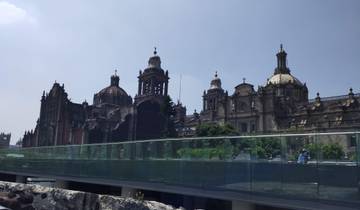 A grand cathedral with domed roofs against a blue sky.