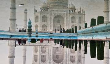 The Taj Mahal reflecting in the water of the surrounding pool
