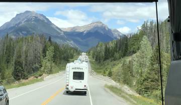 Scenic highway through mountainous landscape with RVs.